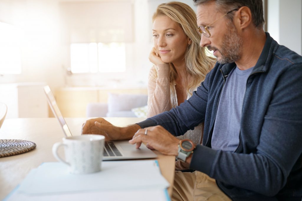 Quickly sell or trade in your car Couple working on laptop